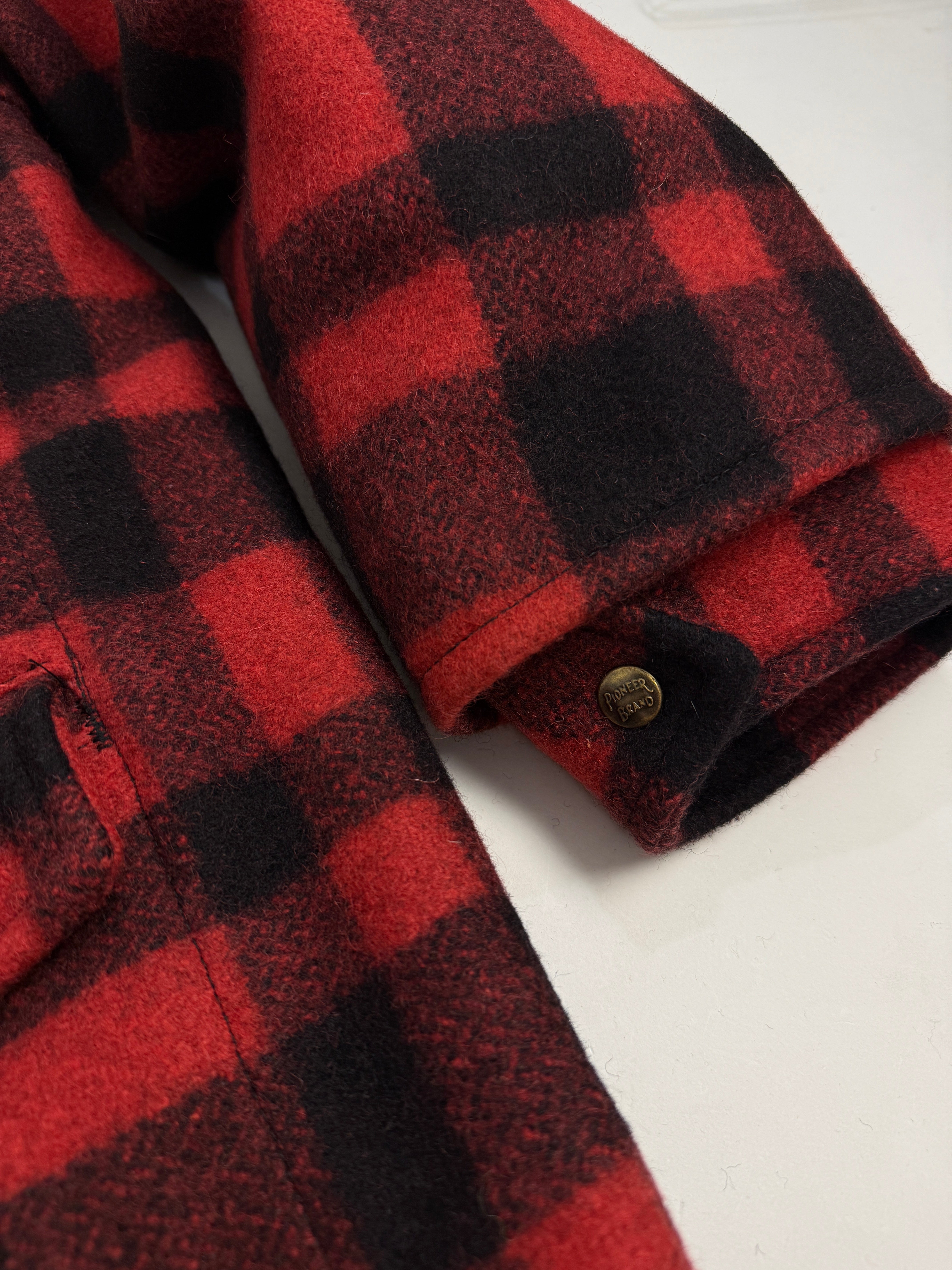 Giacca Lana Vintage Pioneer Sportswear Mackinaw Buffalo Check - dettaglio ravvicinato bottone a pressione Pioneer Brand con testo in rilievo su tessuto Buffalo Check