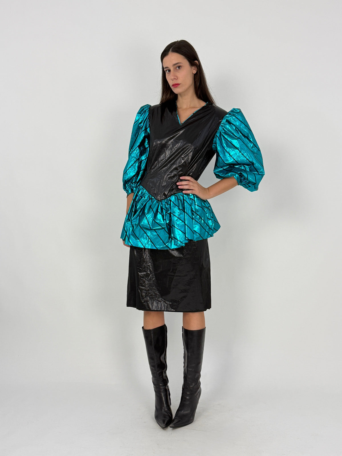 Abito lurex anni 80 - laterale indossato in movimento, peplum a ruota in lurex turchese/nero, manica balloon, silhouette vita segnata