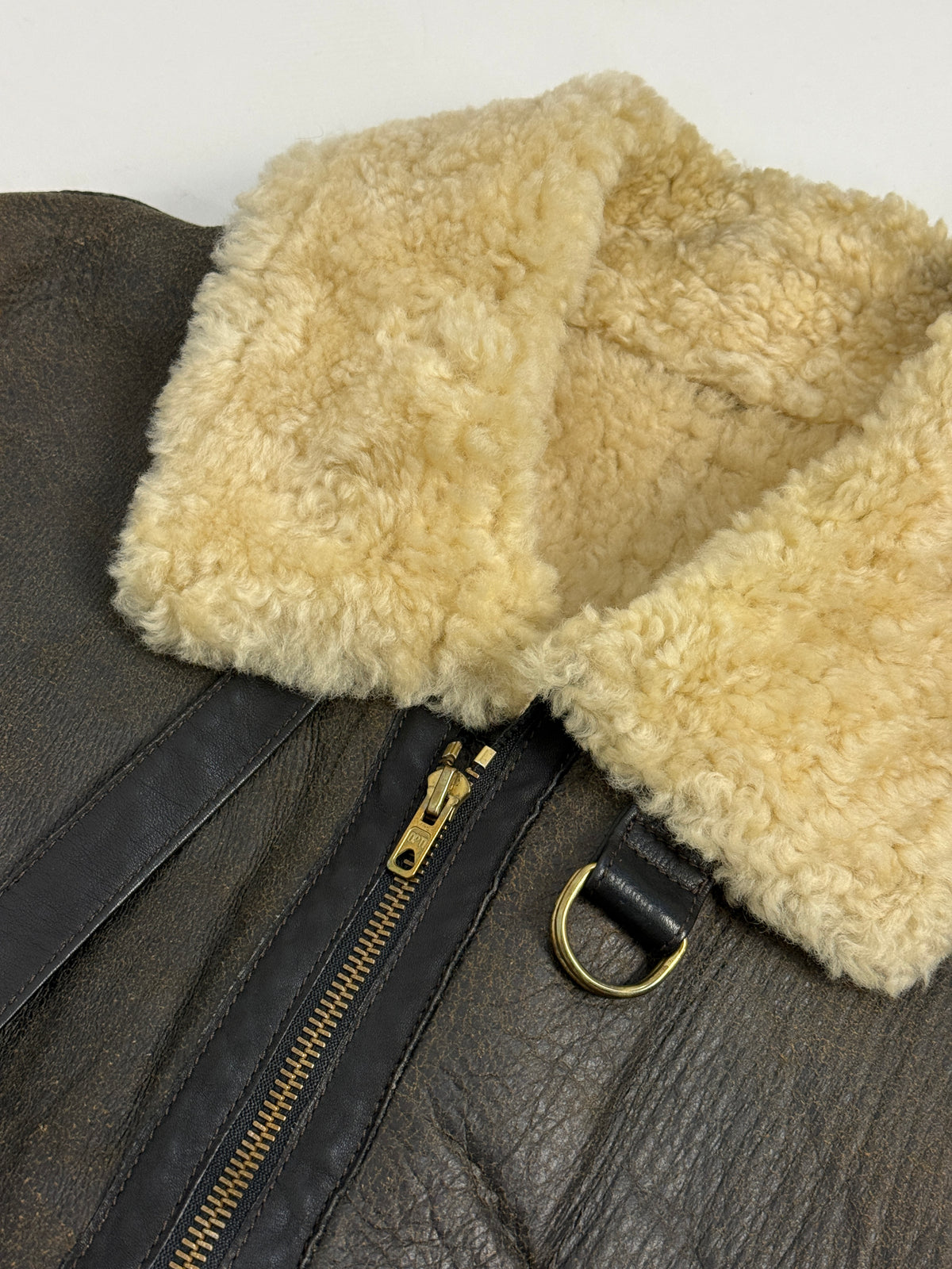 Menichelli B-3 tre quarti frontale indossato - colletto revers ampio shearling riccio avorio aperto, patta tasca petto diagonale sinistra, zip OPTI metallo bronzo cursore D-ring, nappa ebano patina oliva, casco tweed