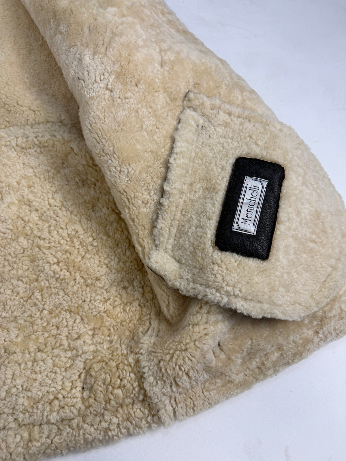 Menichelli bomber montone figura intera laterale - silhouette B-3 oversized volume petto, bordi liberi shearling riccio bianco colletto polsini fondo, nappa ebano oliva, lunghezza cm 77